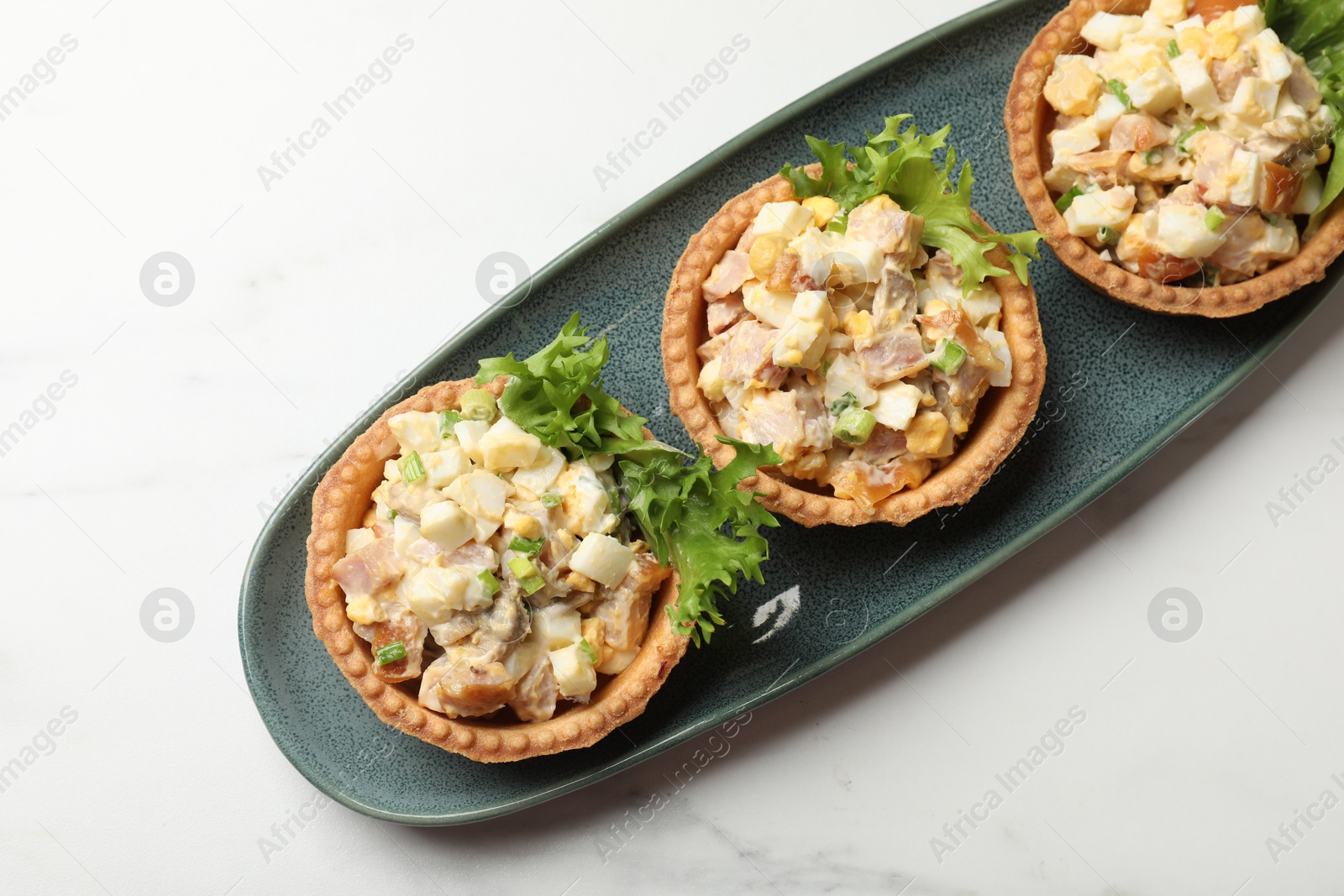 Photo of Tartlets with delicious filling on white marble table, top view