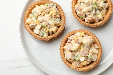 Photo of Tartlets with delicious filling on white marble table, top view