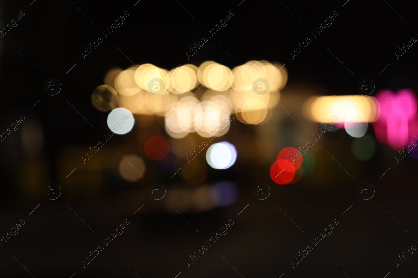 Photo of Blurred view of city street at night. Bokeh effect