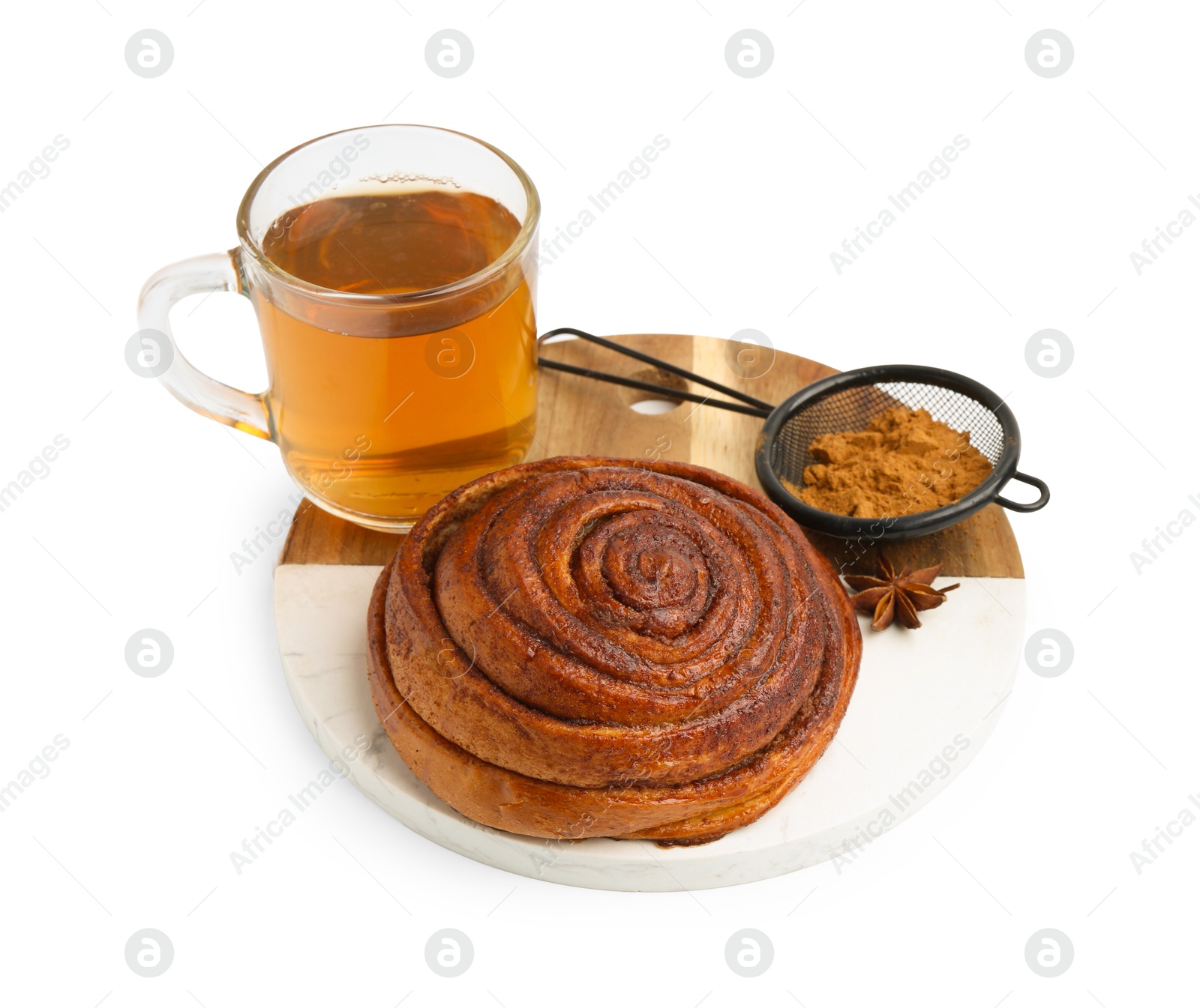 Photo of Delicious cinnamon roll bun, tea and spices isolated on white