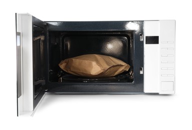 Photo of Open microwave oven with bag of popcorn isolated on white