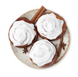 Photo of Tasty cinnamon rolls with cream and spices isolated on white, top view