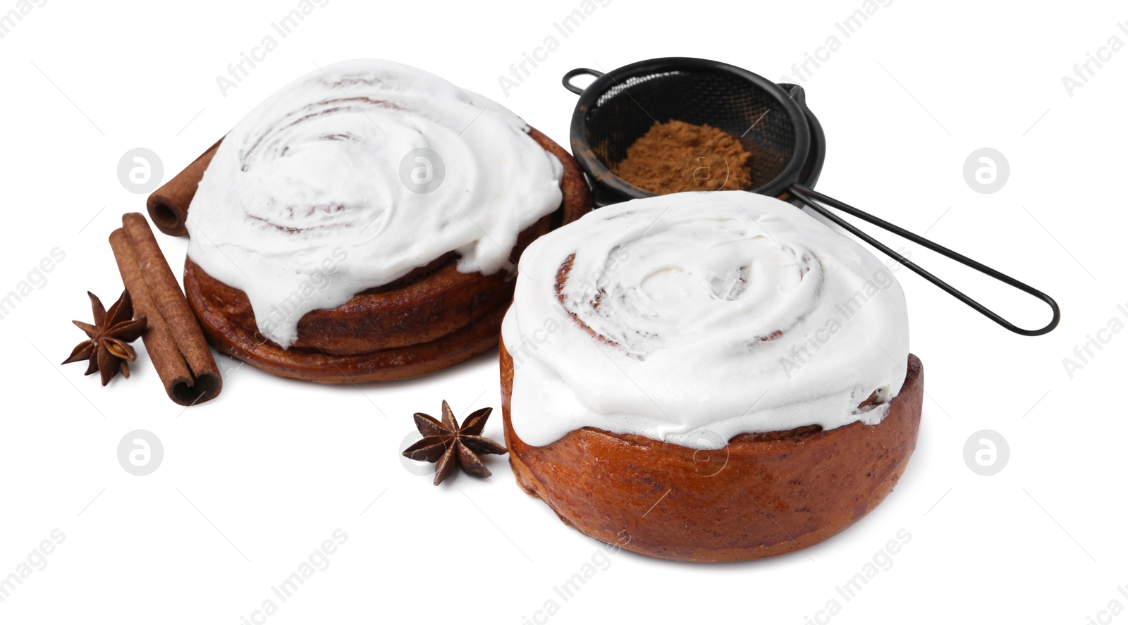 Photo of Tasty cinnamon rolls with cream and spices isolated on white