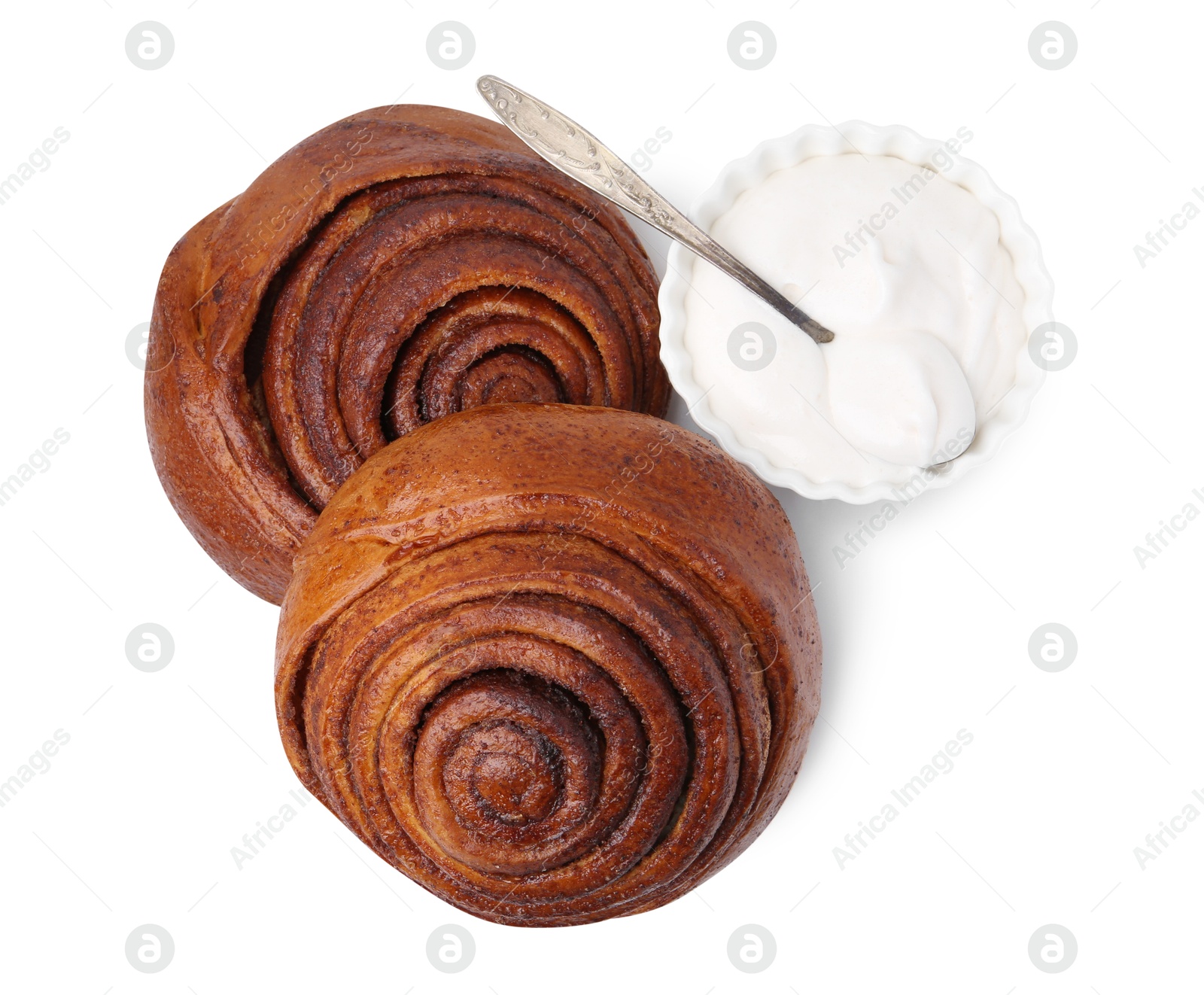 Photo of Tasty cinnamon rolls with cream isolated on white, top view