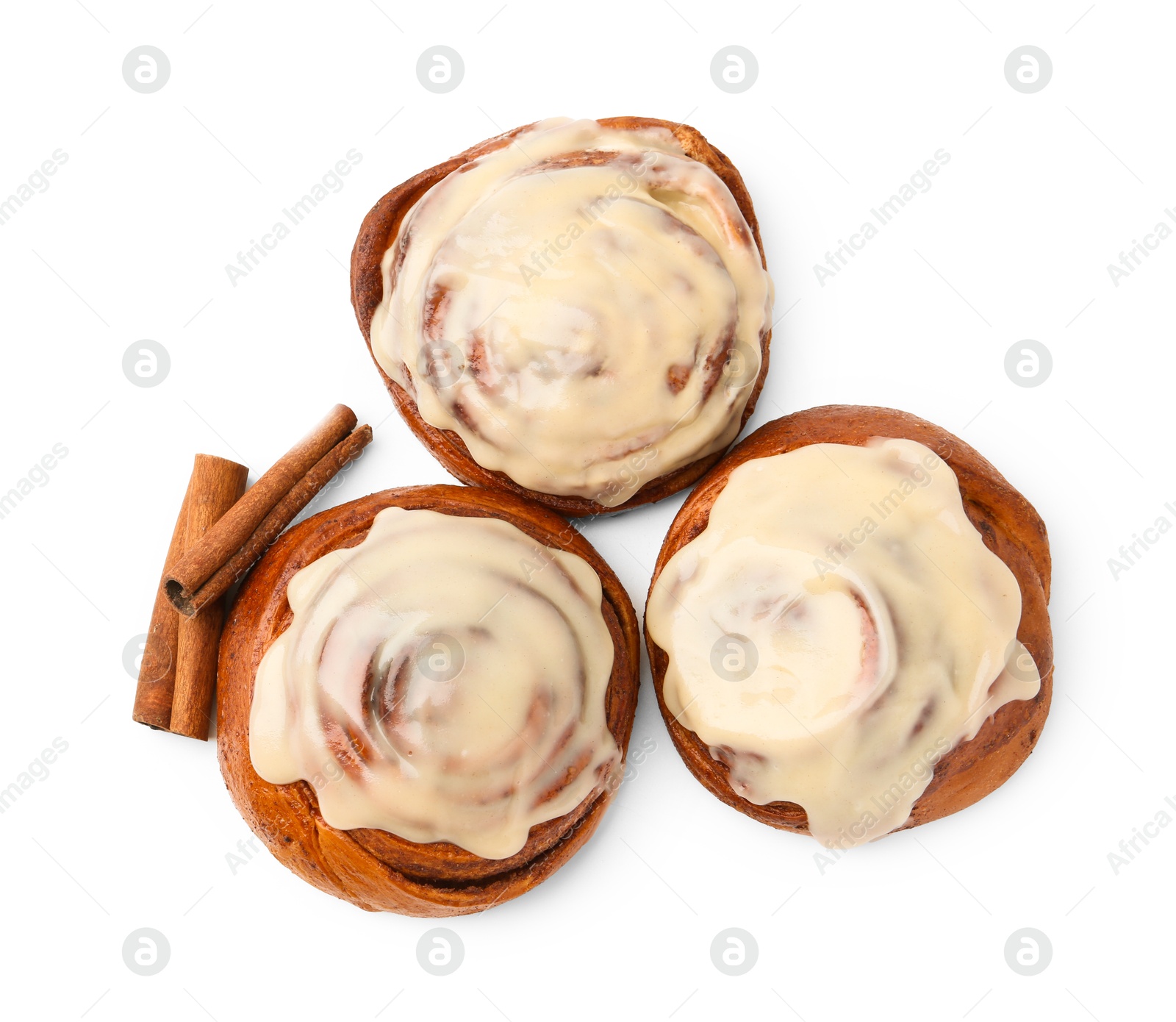 Photo of Tasty cinnamon rolls with cream and spices isolated on white, top view