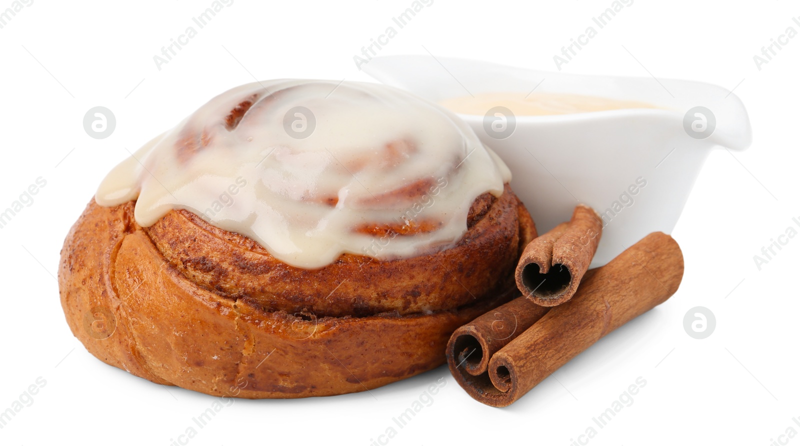 Photo of Tasty cinnamon roll with cream and spices isolated on white