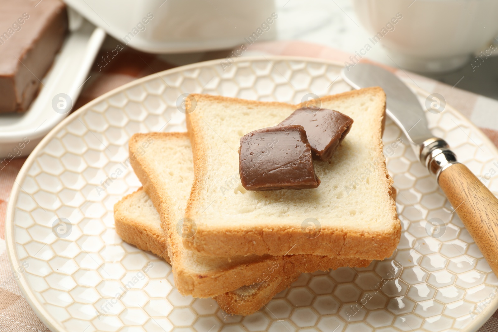 Photo of Sandwiches with chocolate butter and knife on table, closeup