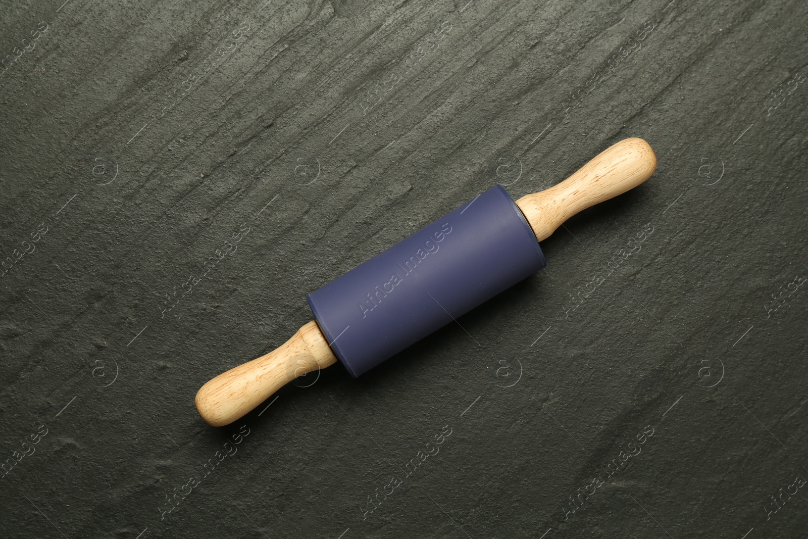 Photo of Rolling pin on dark gray textured table, top view