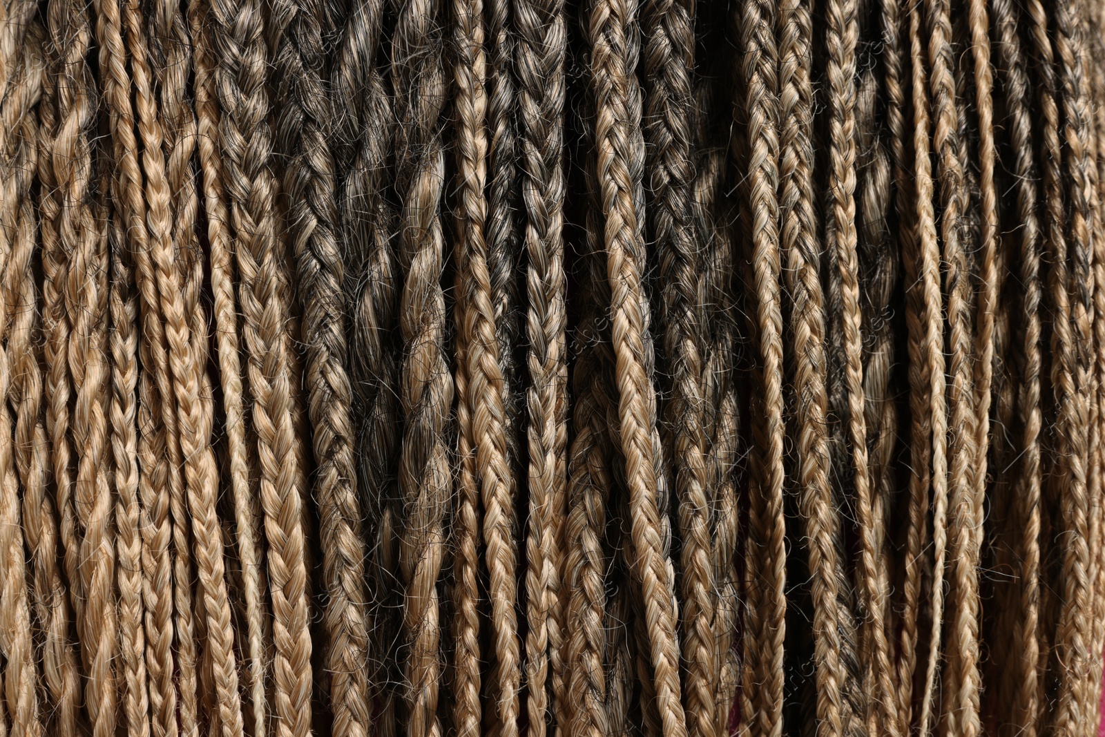 Photo of Many african braids as background, closeup view