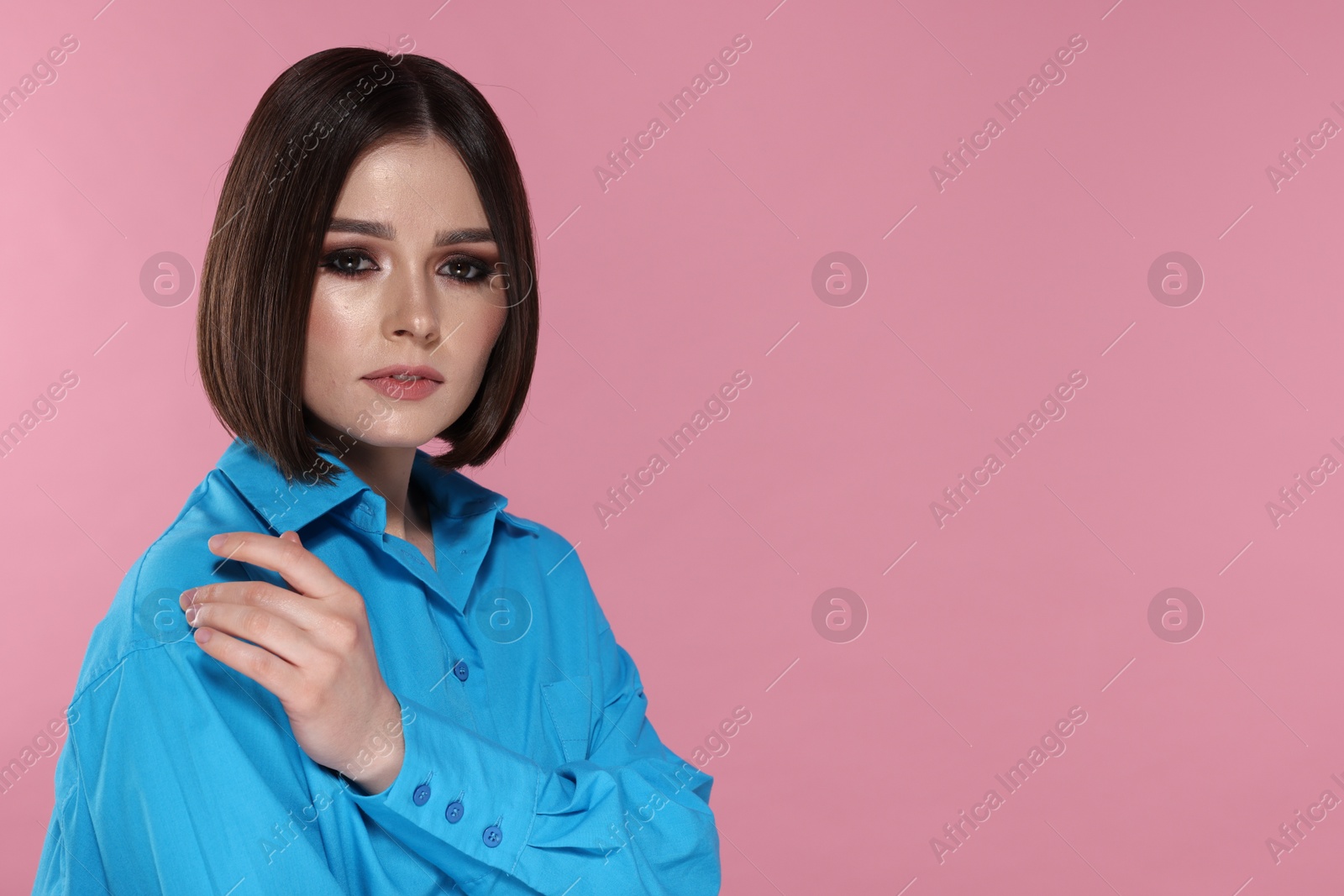 Photo of Portrait of beautiful young woman with gorgeous straight hair on pink background, space for text