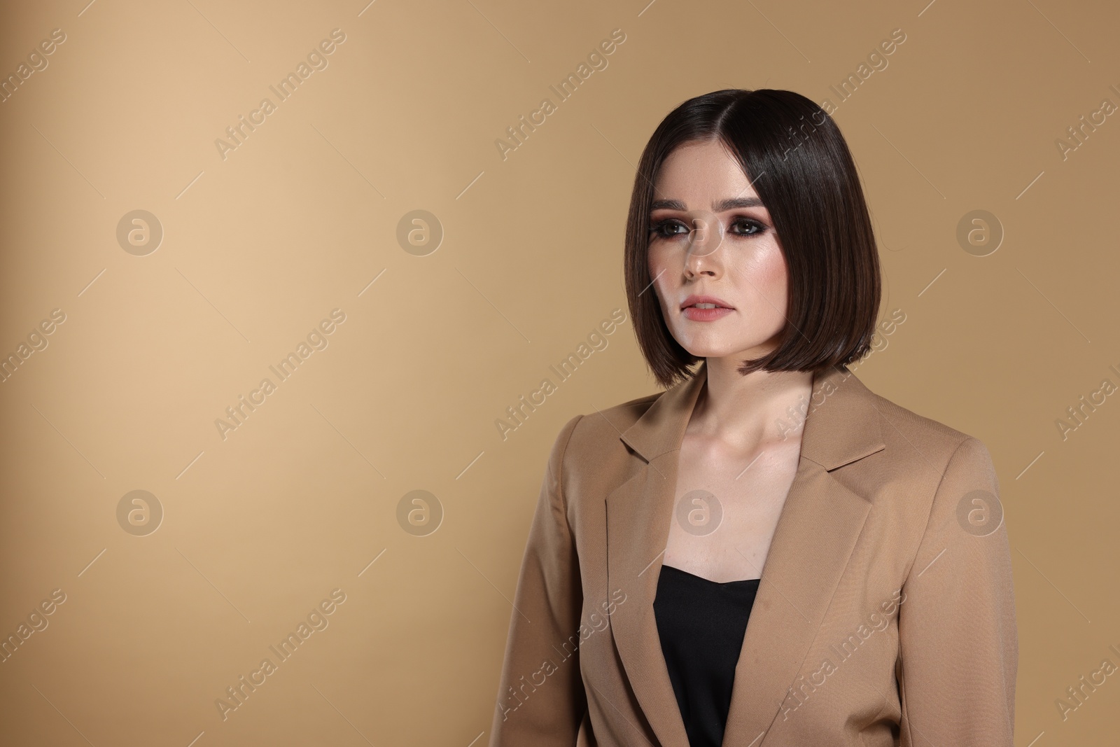 Photo of Portrait of beautiful young woman with gorgeous straight hair on beige background, space for text