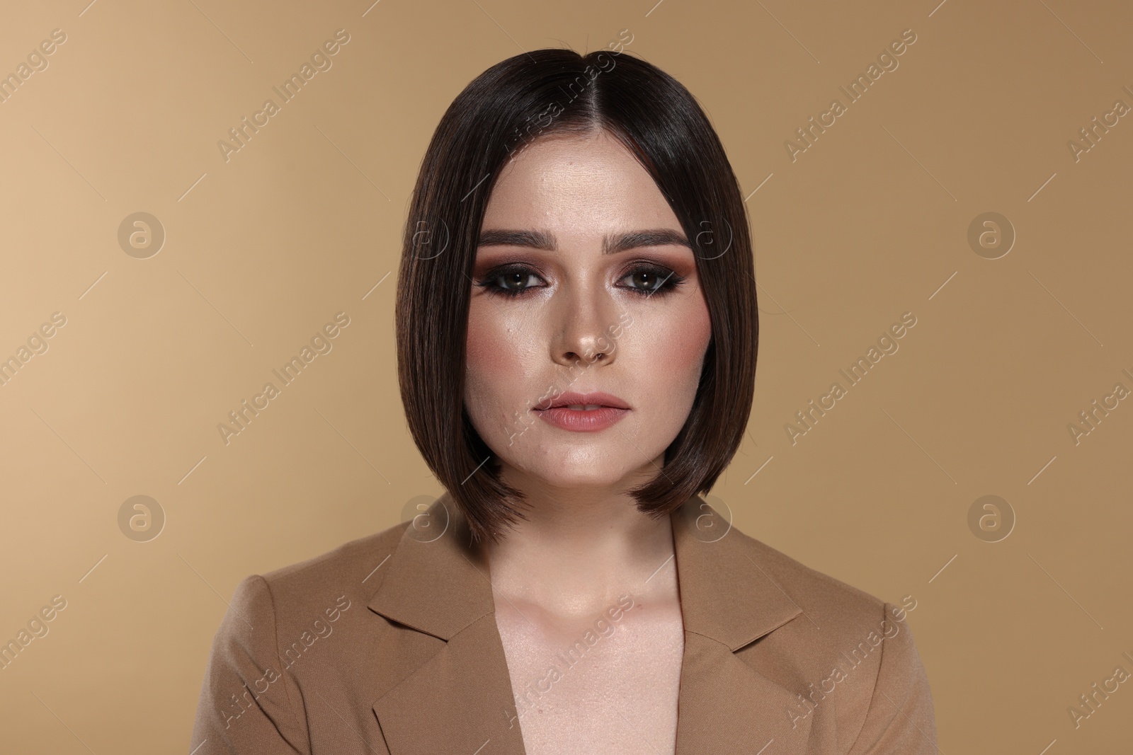 Photo of Portrait of beautiful young woman with gorgeous straight hair on beige background