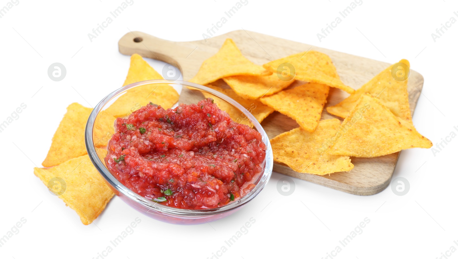 Photo of Spicy salsa sauce in glass bowl and nachos isolated on white