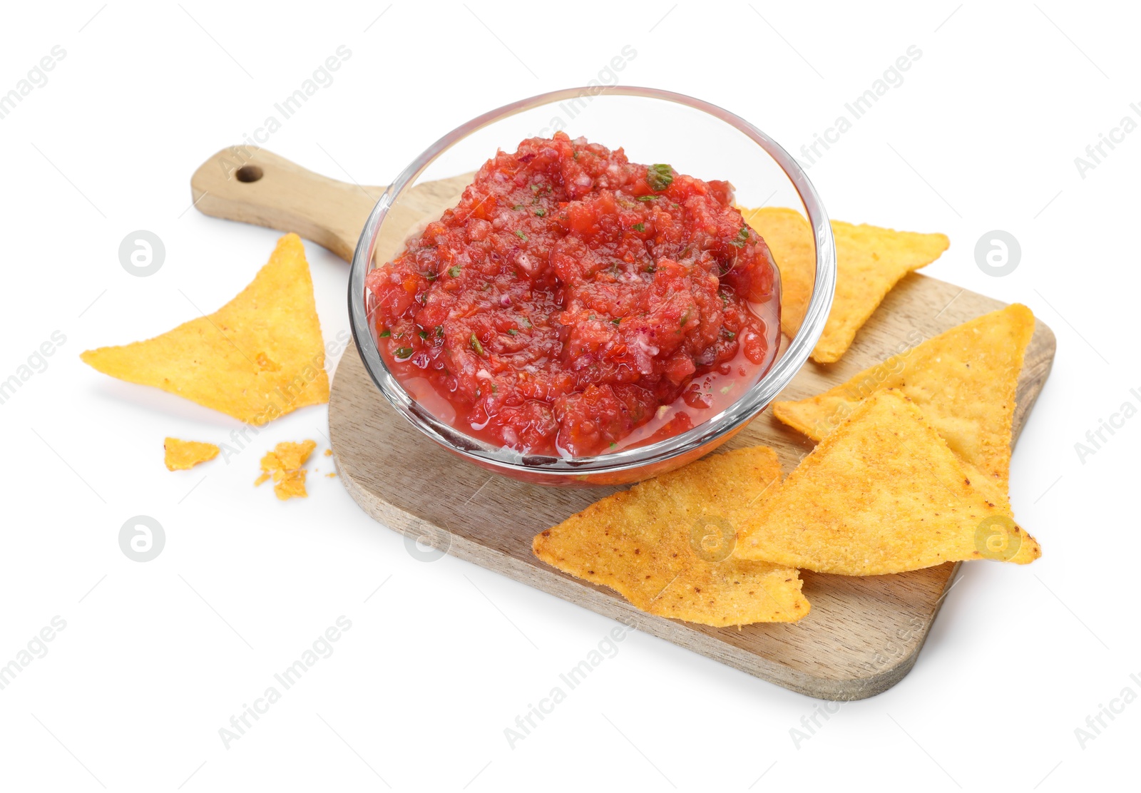 Photo of Spicy salsa sauce in glass bowl and nachos isolated on white