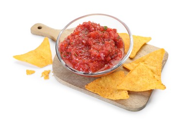 Photo of Spicy salsa sauce in glass bowl and nachos isolated on white