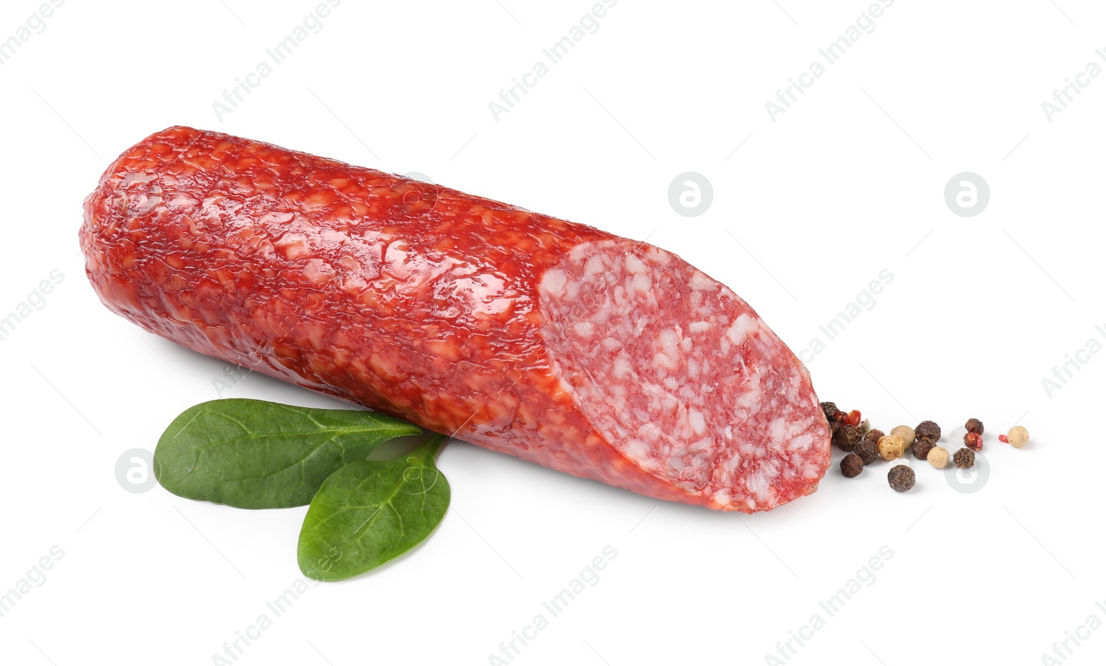 Photo of Piece of delicious smoked sausage with basil and peppercorns isolated on white