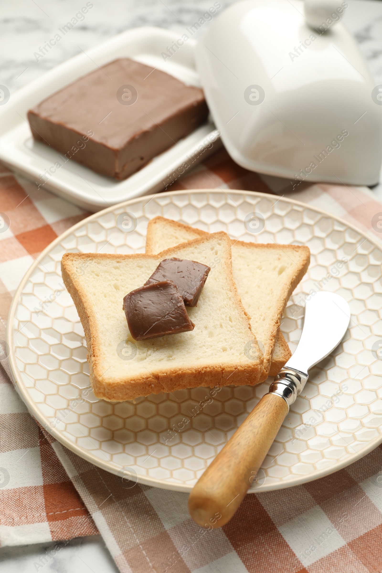 Photo of Sandwiches with chocolate butter and knife on table, closeup