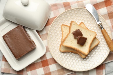 Photo of Sandwiches with chocolate butter and knife on table, flat lay