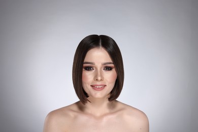 Photo of Portrait of beautiful young happy woman with gorgeous straight hair on light grey background