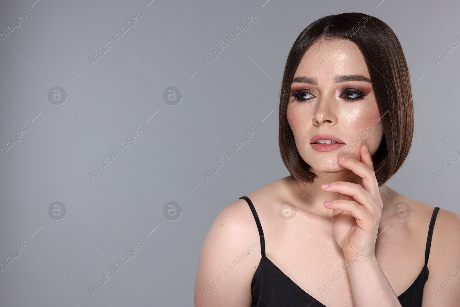 Photo of Portrait of beautiful young woman with gorgeous straight hair on light grey background, space for text