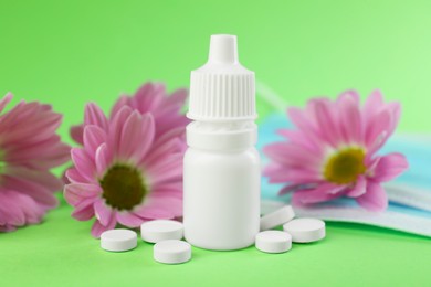 Photo of Allergy treatment. Nasal drops and pills on green background