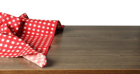 Photo of Red checkered tablecloth on wooden table against white background, closeup