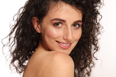 Photo of Beautiful young woman with long curly hair on white background