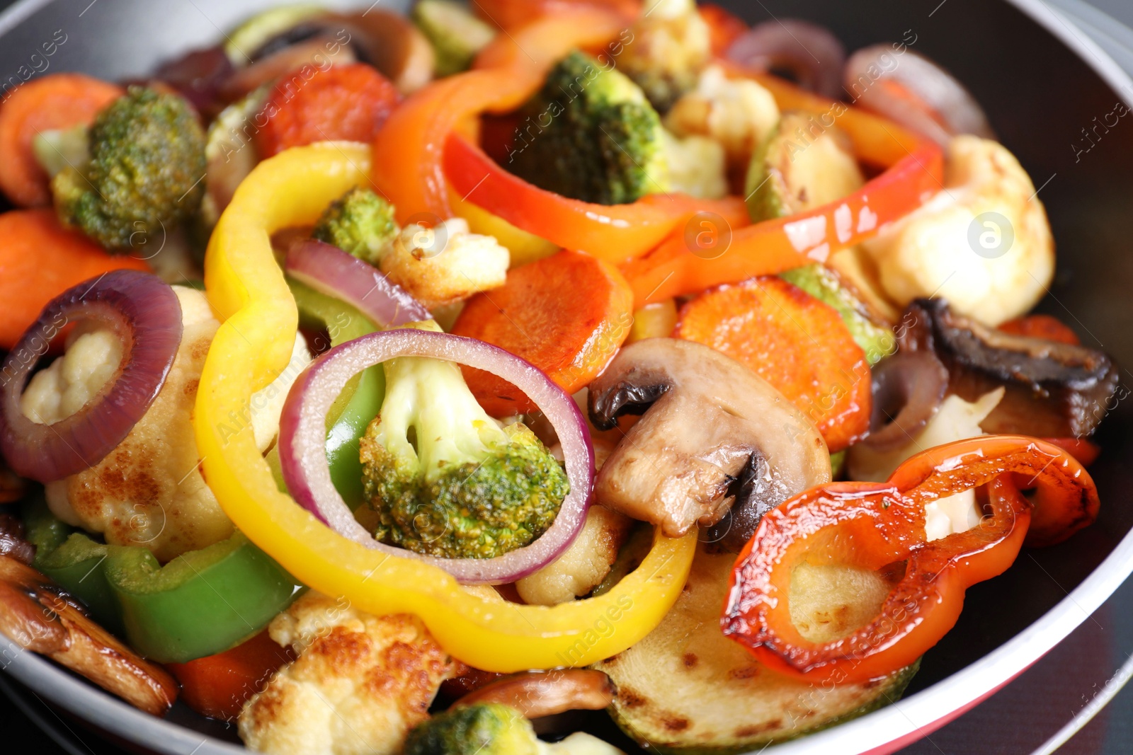 Photo of Frying pan with mix of vegetables and mushrooms, closeup