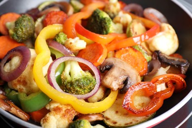 Photo of Frying pan with mix of vegetables and mushrooms, closeup