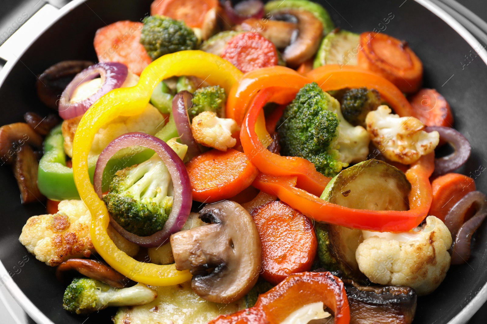 Photo of Frying pan with mix of vegetables and mushrooms, closeup