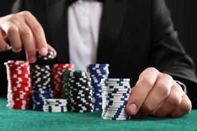 Photo of Man with casino chips playing poker at gambling table, closeup