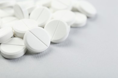 Photo of Many antibiotic pills on grey background, closeup. Space for text