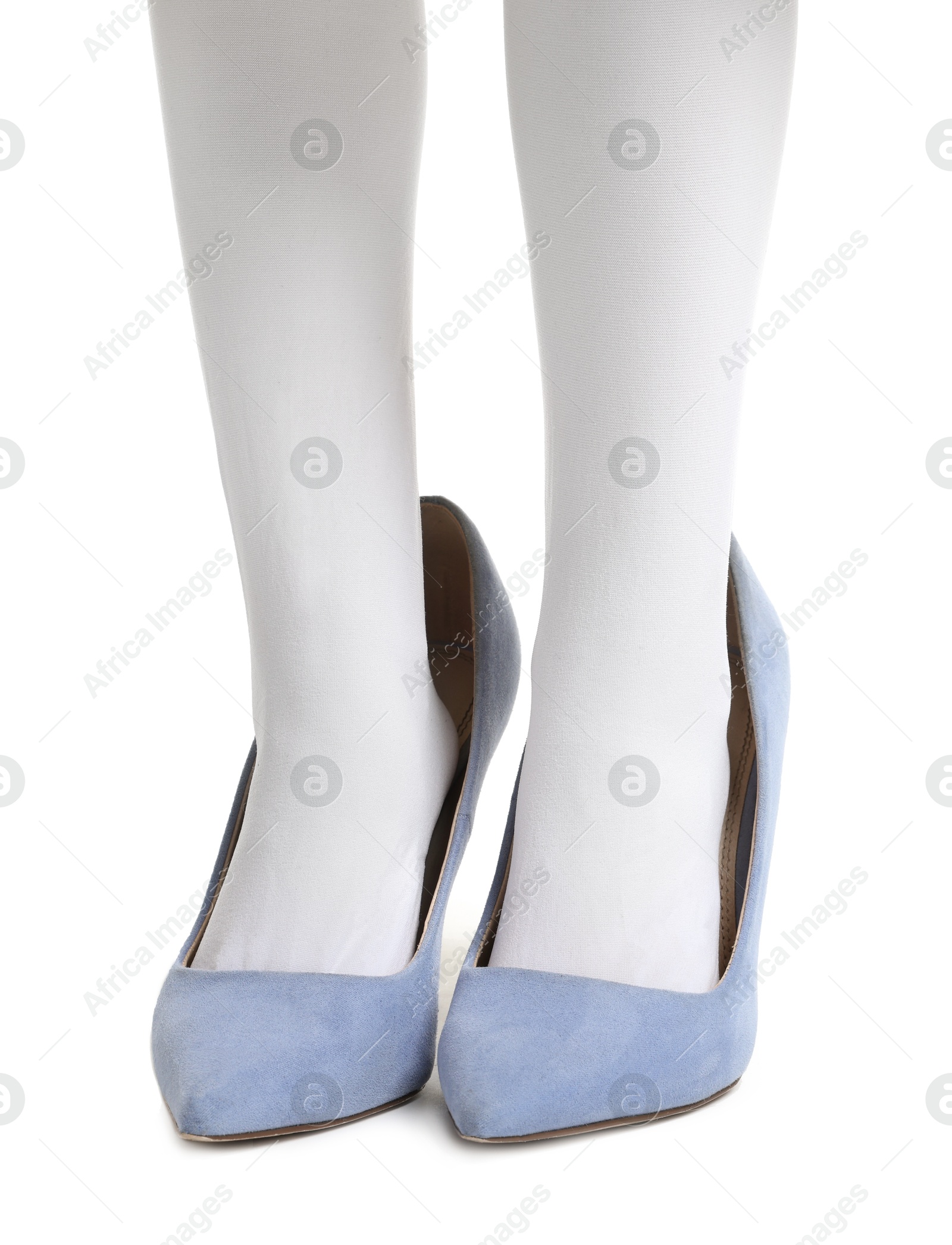 Photo of Little girl wearing oversized high heeled shoes on white background, closeup