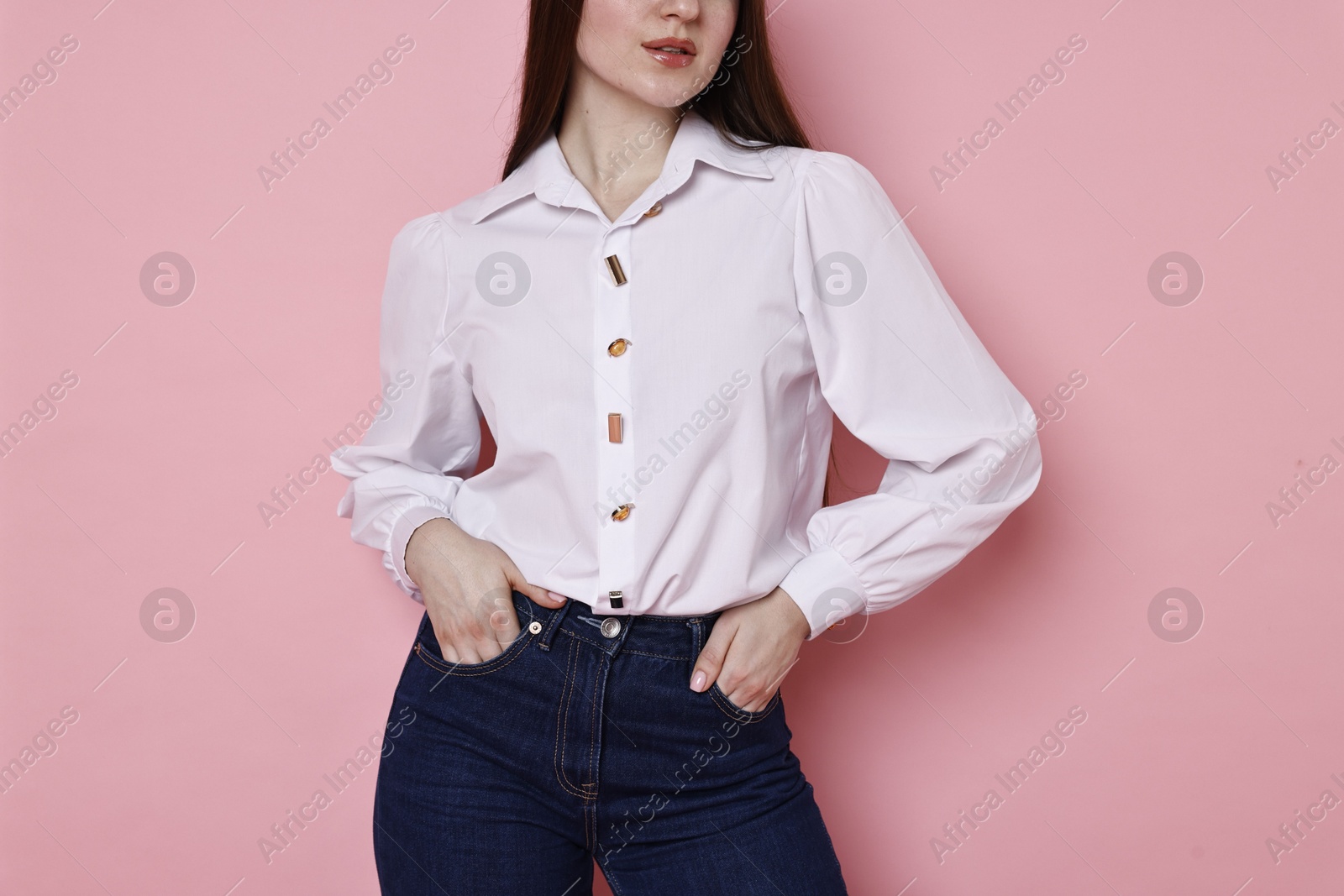 Photo of Woman in stylish jeans on pink background, closeup