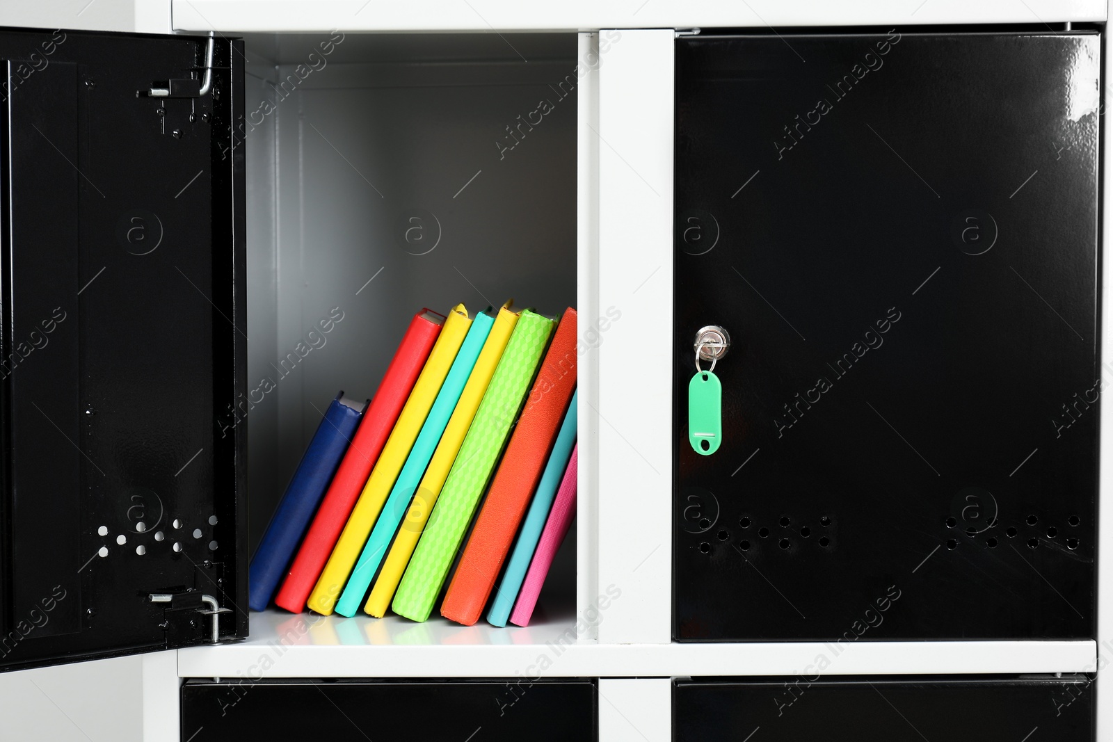 Photo of Lockers with school supplies on light background, closeup