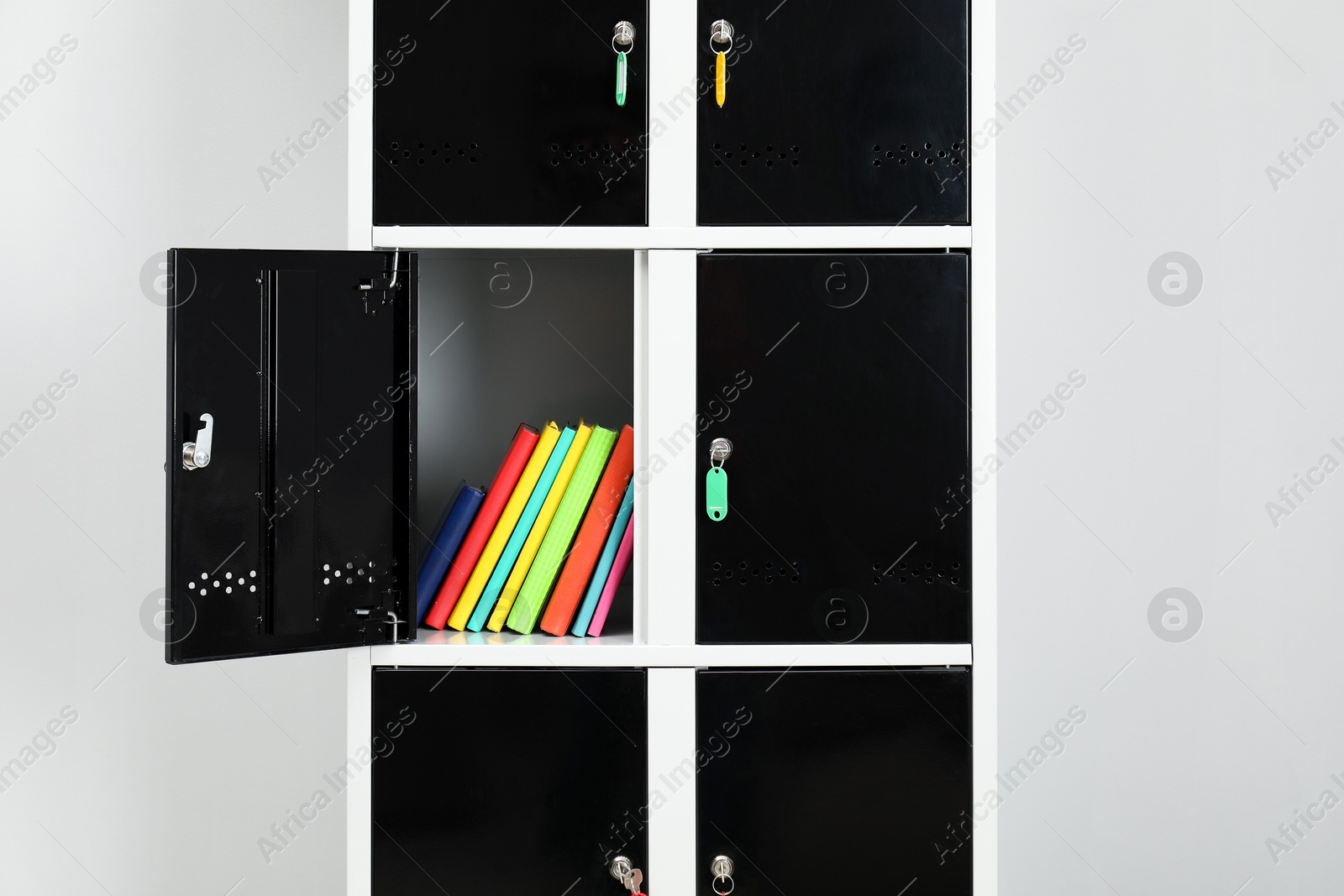 Photo of Lockers with school supplies on light background