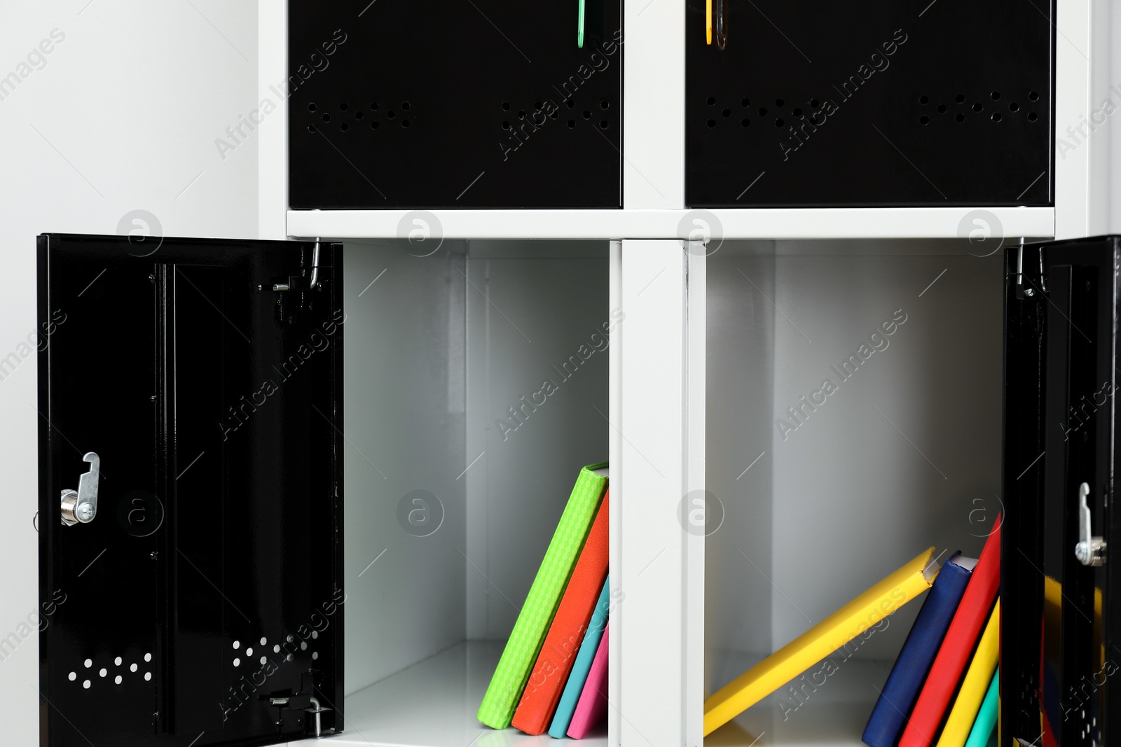 Photo of Lockers with school supplies on light background, closeup