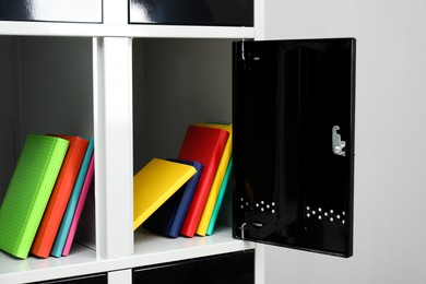 Photo of Lockers with school supplies on light background, closeup