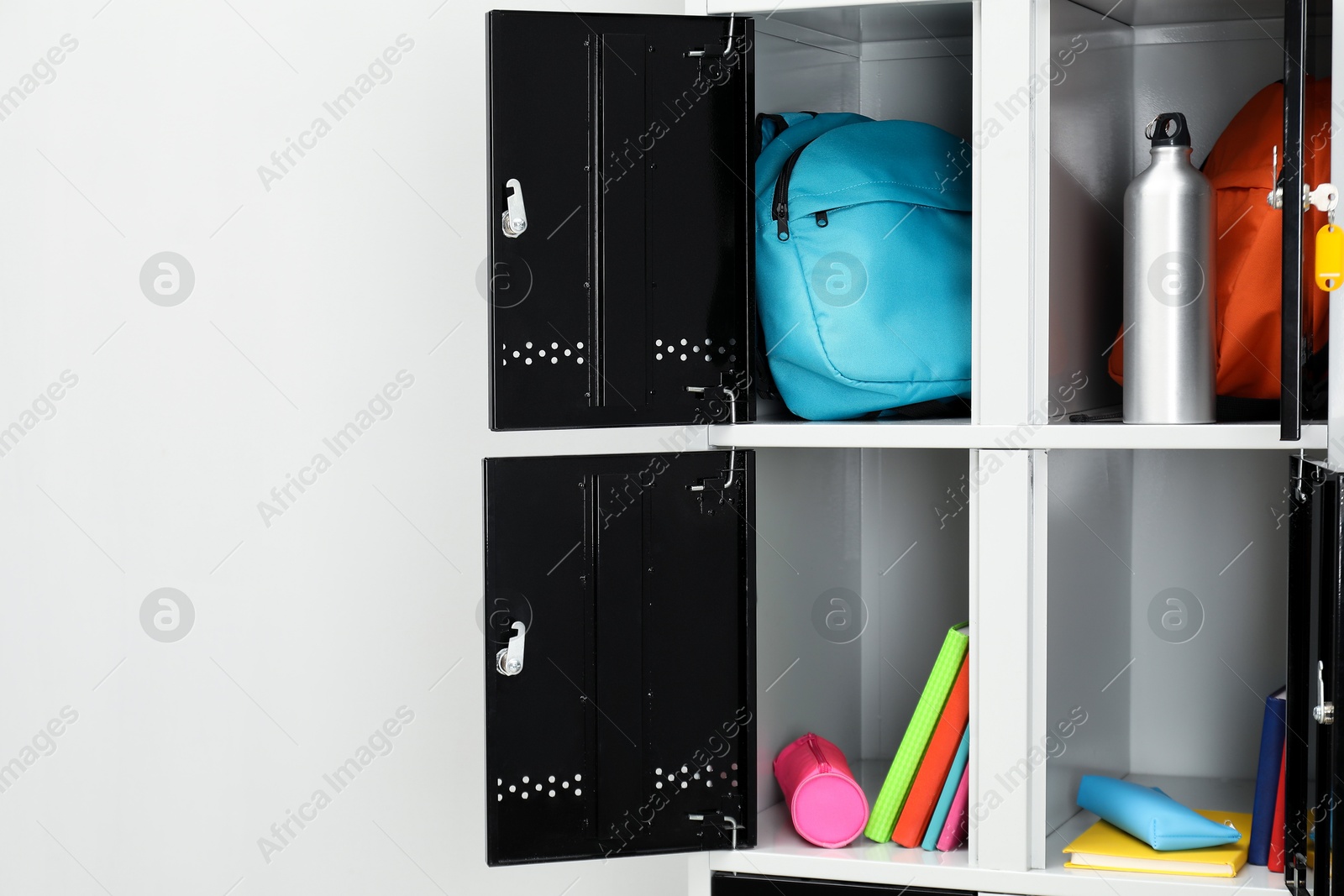 Photo of Lockers with school supplies on light background