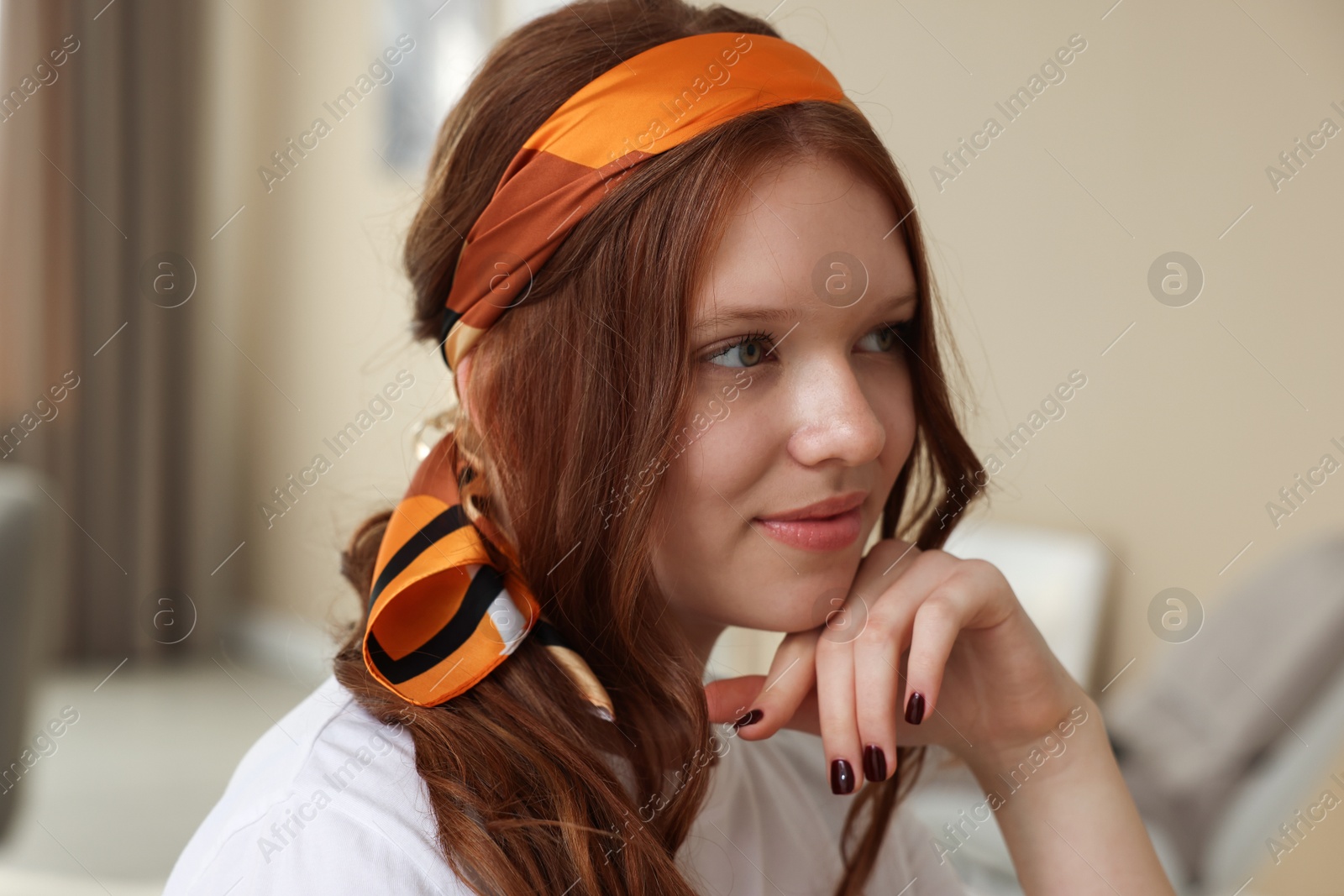 Photo of Red-haired teenage girl with stylish bandana indoors