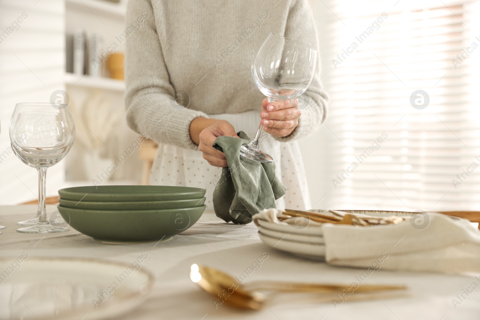 Photo of Woman setting table for dinner at home, closeup