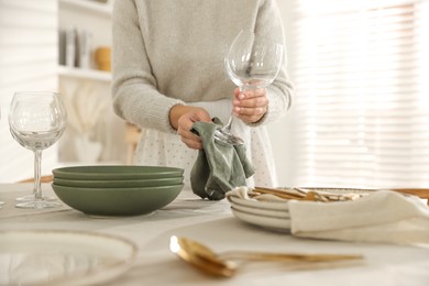 Photo of Woman setting table for dinner at home, closeup