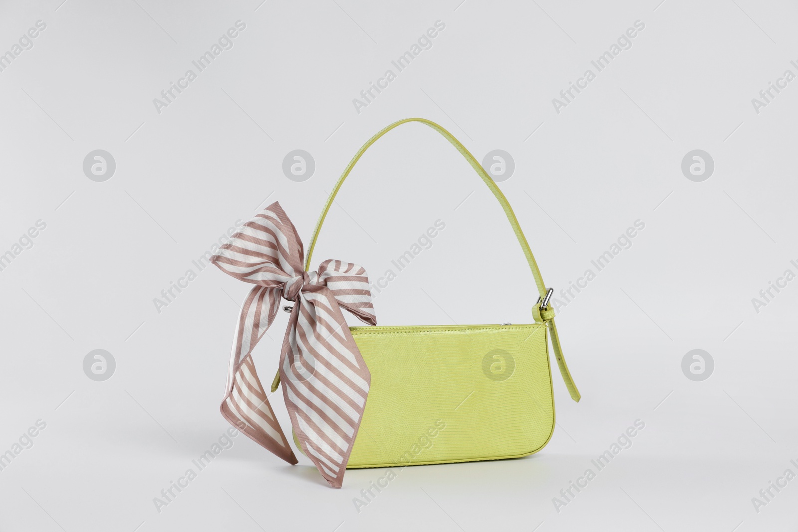 Photo of Elegant women baguette handbag with bow on white background