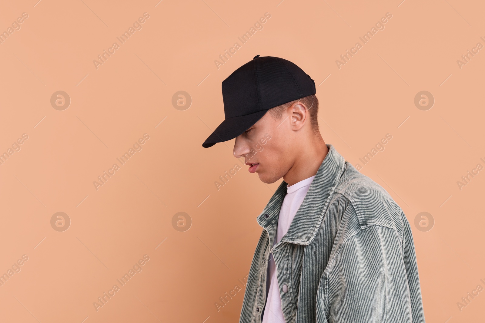 Photo of Man in stylish baseball cap on beige background. Mockup for design