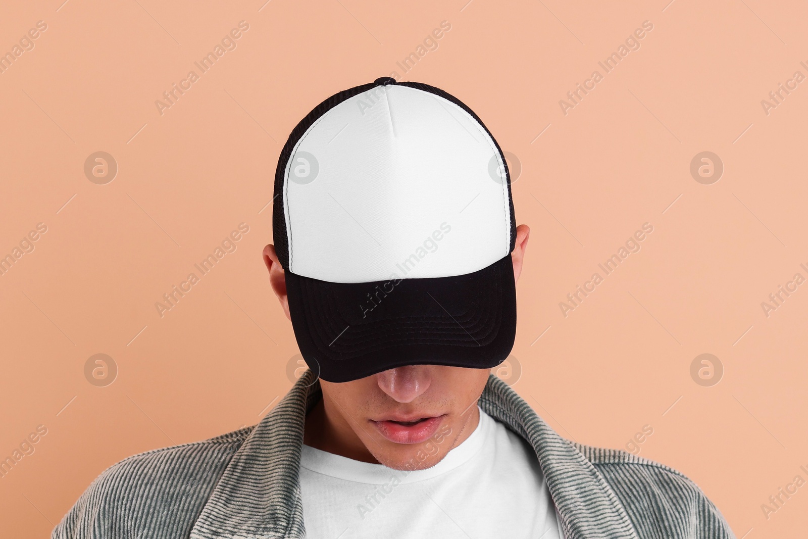 Photo of Man in stylish baseball cap on beige background. Mockup for design