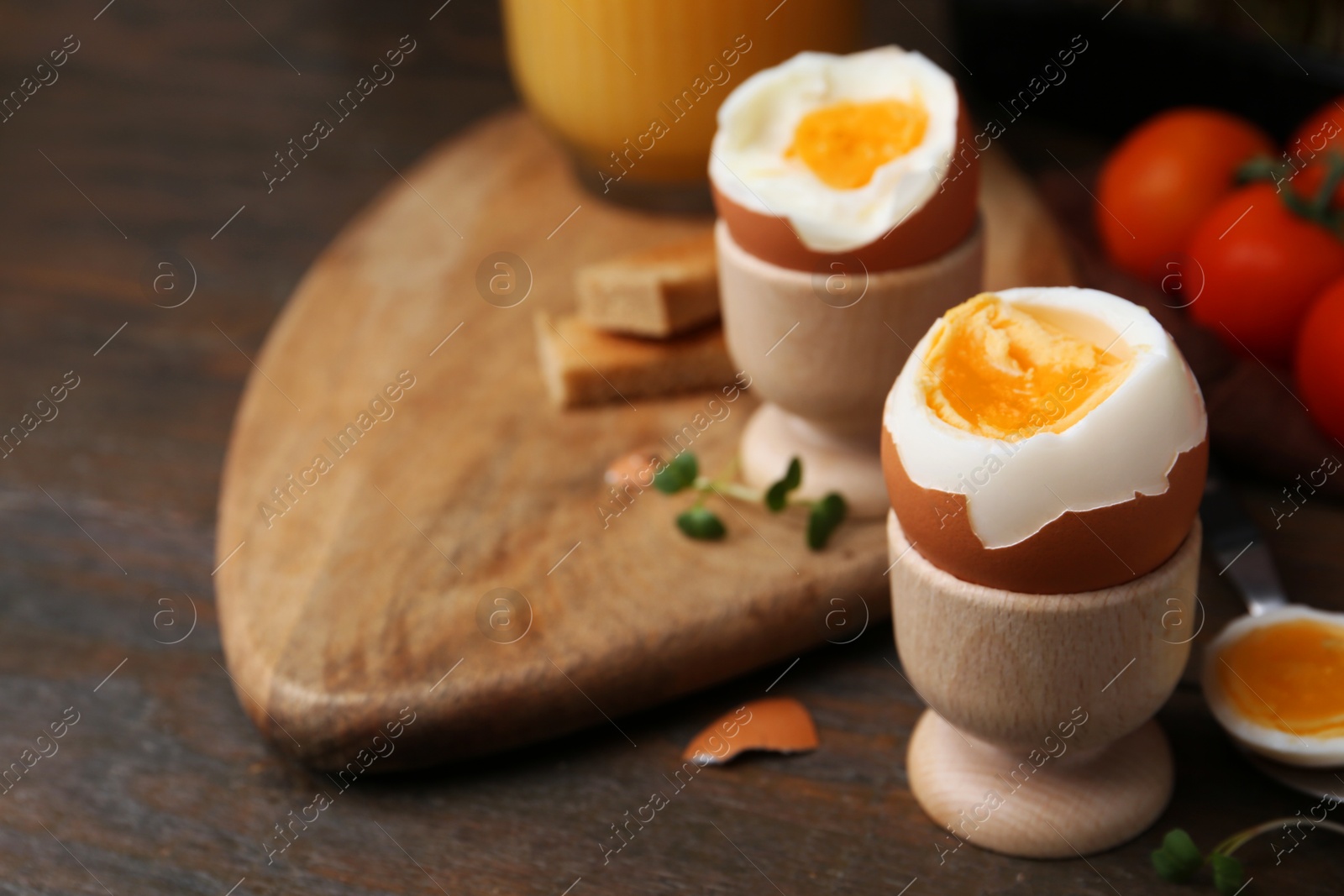 Photo of Soft boiled eggs on wooden table, closeup. Space for text