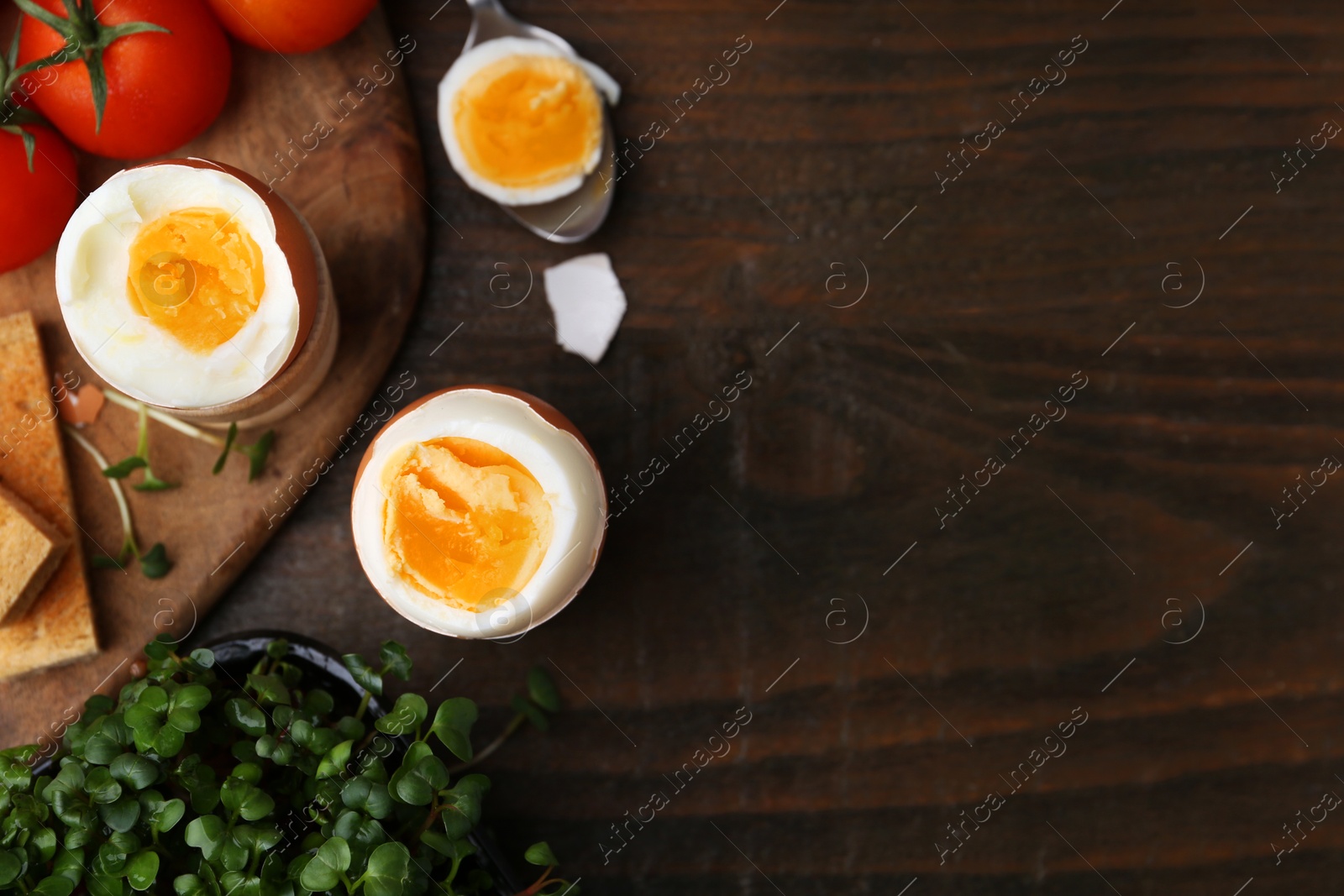 Photo of Soft boiled eggs on wooden table, flat lay. Space for text