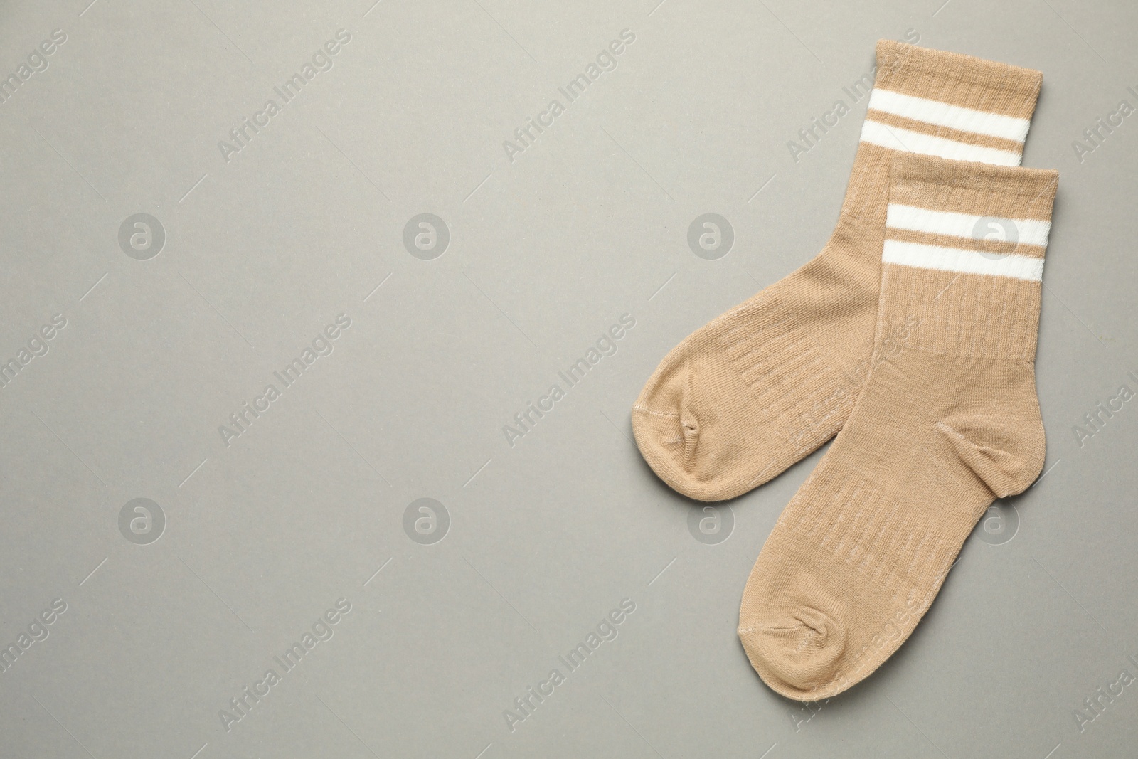 Photo of Pair of soft socks on light grey background, top view. Space for text