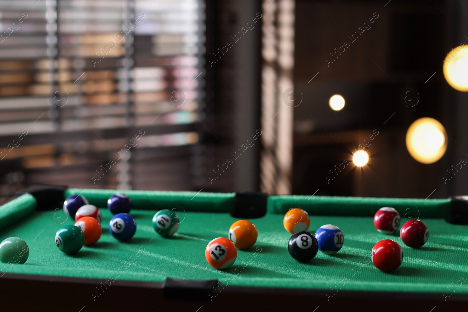 Photo of Many colorful billiard balls on green table indoors, space for text