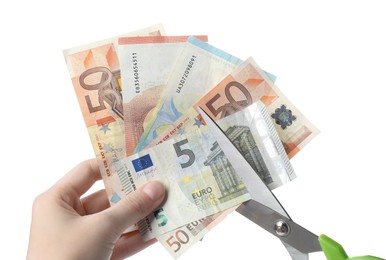 Photo of Woman cutting euro banknotes on white background, closeup